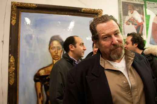 Julian Schnabel in front of his painting.